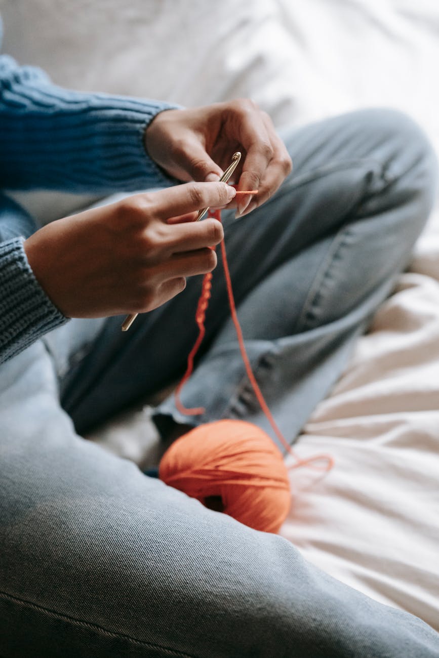 A person working on a crochet project.